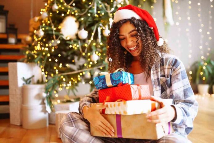 young-woman-with-christmas-gifts-at-home-near-chri-2023-11-27-05-07-47-utc (1)