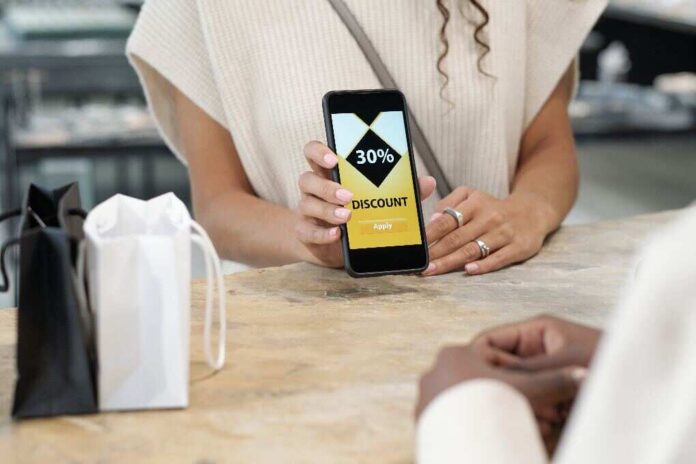 hands-of-young-consumer-showing-discount-coupon-in-2023-11-27-05-22-19-utc (1)